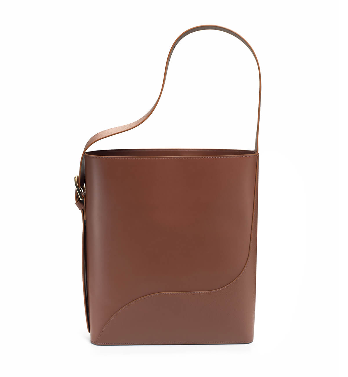 A brown leather tote bag with a structured design, an adjustable strap, and a gold finish buckle.